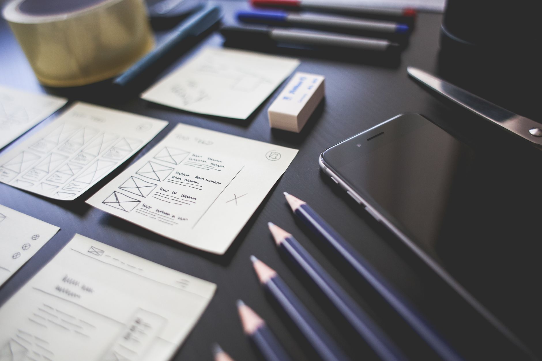 Modern creative workspace with sticky notes and wireframe sketches